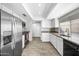 Bright kitchen with white cabinets, stainless appliances, granite counters and wood-look tile floors at 8742 E Via De La Luna --, Scottsdale, AZ 85258