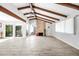 Spacious living area with a brick fireplace, beams, and a view of the outdoors at 8742 E Via De La Luna --, Scottsdale, AZ 85258