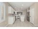 Bright kitchen featuring white cabinets, stainless steel appliances, and a center island at 896 E Indian Wells Pl, Chandler, AZ 85249