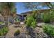 Inviting desert landscaping with a dry riverbed and mature plants adds curb appeal to this home's front yard at 9671 E Cavalry Dr, Scottsdale, AZ 85262