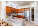Gourmet kitchen with stainless steel appliances, granite countertops, and custom cabinetry at 9671 E Cavalry Dr, Scottsdale, AZ 85262