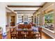 Open-concept living and dining area with hardwood floors, fireplace, and built-in shelving at 9671 E Cavalry Dr, Scottsdale, AZ 85262