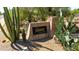 Community signage for The Legends at Legend Trail surrounded by desert landscape at 9671 E Cavalry Dr, Scottsdale, AZ 85262