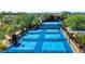 Aerial view of multiple blue tennis and pickleball courts in a gated community at 9671 E Cavalry Dr, Scottsdale, AZ 85262