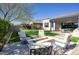 Inviting backyard featuring an outdoor fire pit, patio, and lush landscaping at 9671 E West View Dr, Scottsdale, AZ 85255