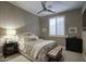 Cozy bedroom featuring a comfy bed, ceiling fan, plantation shutters, and a dark nightstand at 9671 E West View Dr, Scottsdale, AZ 85255