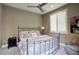 Comfortable bedroom featuring an iron bed frame, decorative pillows, and a cozy armchair for a relaxing retreat at 9671 E West View Dr, Scottsdale, AZ 85255