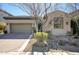 Charming single-story home featuring a well-manicured yard, mature landscaping, and a two-car garage, showcasing curb appeal at 9671 E West View Dr, Scottsdale, AZ 85255