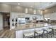 Gourmet kitchen with stainless steel appliances, a large center island, and custom white cabinetry, creating a chef's dream at 9671 E West View Dr, Scottsdale, AZ 85255