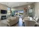 Elegant living and dining area with a brick fireplace, stylish decor, and seamless access to the outdoor living space at 9671 E West View Dr, Scottsdale, AZ 85255