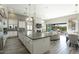 Bright, open-concept living room features modern decor, a large kitchen island, and an easy flow to the backyard oasis at 9671 E West View Dr, Scottsdale, AZ 85255