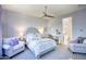 Bright main bedroom featuring a luxurious bed, sitting area, and an ensuite bathroom with a soaking tub at 9671 E West View Dr, Scottsdale, AZ 85255