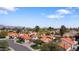 Scenic aerial view of a residential area with red-tiled roofs surrounded by green trees and mountain views at 10076 E Calle De Cielo E Cir, Scottsdale, AZ 85258