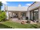 Relaxing backyard with covered patio, lush artificial turf, and charming desert landscaping at 10076 E Calle De Cielo E Cir, Scottsdale, AZ 85258