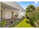 A covered patio with brick pavers, a seating area, and a landscaped backyard at 10076 E Calle De Cielo E Cir, Scottsdale, AZ 85258