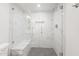 New glass shower with white marble-patterned tiles, bench, and black and white mosaic floor at 10076 E Calle De Cielo E Cir, Scottsdale, AZ 85258