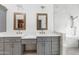 Modern bathroom featuring dual sinks, grey cabinets, and marble shower with decorative tiles at 10076 E Calle De Cielo E Cir, Scottsdale, AZ 85258