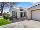 Contemporary home with a stucco exterior, red brick accents, desert landscaping, and a driveway at 10076 E Calle De Cielo E Cir, Scottsdale, AZ 85258