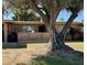 Charming brick home featuring mature landscaping and a welcoming front facade at 10323 W Deanne Dr, Sun City, AZ 85351