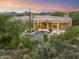 Beautiful aerial view of the property showcasing the pool, desert landscape, and mountain views at 10379 E White Feather Ln, Scottsdale, AZ 85262