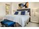 Cozy bedroom with accent pillows, bedside tables, and modern art at 10379 E White Feather Ln, Scottsdale, AZ 85262
