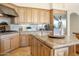 Bright kitchen features stainless steel fridge and hood, and a large kitchen island at 10379 E White Feather Ln, Scottsdale, AZ 85262