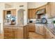 Spacious kitchen with stainless steel hood, kitchen island, and granite countertops at 10379 E White Feather Ln, Scottsdale, AZ 85262