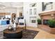 Spacious open concept living room with stone fireplace and view to the dining area at 10379 E White Feather Ln, Scottsdale, AZ 85262