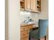 Cozy office nook features built-in cabinets and granite desktop at 10379 E White Feather Ln, Scottsdale, AZ 85262