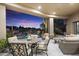 Stunning covered patio overlooking the sparkling pool, waterfall, and lush desert landscape at 10379 E White Feather Ln, Scottsdale, AZ 85262