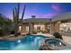 Backyard pool with water feature, patio and well-appointed outdoor living space at 10379 E White Feather Ln, Scottsdale, AZ 85262