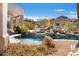 Backyard pool featuring a waterfall feature, desert landscaping, and ample space for lounging at 10379 E White Feather Ln, Scottsdale, AZ 85262