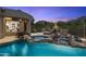 Beautiful pool and spa area with rock waterfall, lounge seating, and desert landscaping at 10379 E White Feather Ln, Scottsdale, AZ 85262