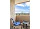 Relaxing balcony view with comfortable chair and table against a sunny sky at 10410 N Cave Creek Rd # 2114, Phoenix, AZ 85020