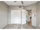 Bedroom featuring wood-look floors, a ceiling fan, and a closet with sliding doors at 10410 N Cave Creek Rd # 2114, Phoenix, AZ 85020