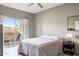 Bedroom featuring a queen bed, ceiling fan, and access to a private balcony with seating at 10410 N Cave Creek Rd # 2114, Phoenix, AZ 85020