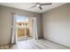 Bright bedroom featuring a ceiling fan and sliding glass door with access to an outdoor balcony at 10410 N Cave Creek Rd # 2114, Phoenix, AZ 85020