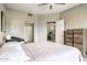 Bedroom showcases a queen bed, ceiling fan, and doorway to the workout room at 10410 N Cave Creek Rd # 2114, Phoenix, AZ 85020