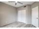 Clean bedroom featuring wood-look floors, a ceiling fan, and a closet with sliding doors at 10410 N Cave Creek Rd # 2114, Phoenix, AZ 85020
