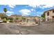 Gated community entrance featuring a water fountain, manicured landscaping, and mountain views at 10410 N Cave Creek Rd # 2114, Phoenix, AZ 85020