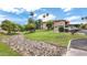 Well-maintained community grounds with lush green grass, mature trees, and a dry creek bed at 10410 N Cave Creek Rd # 2114, Phoenix, AZ 85020