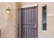 Close-up of the front door featuring a security screen, outdoor light, and unit number at 10410 N Cave Creek Rd # 2114, Phoenix, AZ 85020