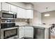 Efficient kitchen featuring modern appliances, ample counter space, and white cabinetry at 10410 N Cave Creek Rd # 2114, Phoenix, AZ 85020