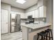 Modern kitchen featuring white cabinets, stainless steel appliances, and breakfast bar at 10410 N Cave Creek Rd # 2114, Phoenix, AZ 85020