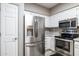 Bright kitchen with white cabinets, stainless steel appliances, and light countertops at 10410 N Cave Creek Rd # 2114, Phoenix, AZ 85020