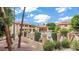 Beautiful community pool area with covered seating, lush landscaping, and wrought iron fencing at 10410 N Cave Creek Rd # 2114, Phoenix, AZ 85020