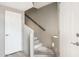 Bright stairway with white wood stairs and gray walls leading upstairs to the upper level of the home at 10410 N Cave Creek Rd # 2114, Phoenix, AZ 85020