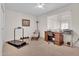 Bright bedroom featuring a dedicated office space and exercise equipment at 10414 N 105Th Ave, Sun City, AZ 85351