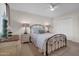 Comfortable bedroom with a decorative wrought iron bed frame and neutral decor at 10414 N 105Th Ave, Sun City, AZ 85351