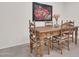 Cozy dining area features rustic wooden table and seating near a floral art piece at 10414 N 105Th Ave, Sun City, AZ 85351